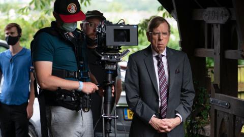 Timothy Spall in the Sixth Commandment with a camera operator behind him