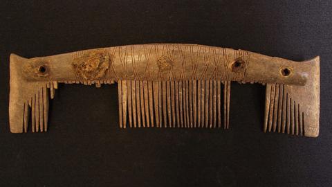 Carved Viking comb etched with design and with about half its teeth left