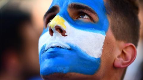 Macri supporter with face painted like Argentine flag