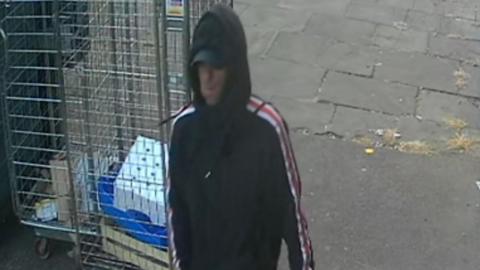 CCTV image of a man with hood up