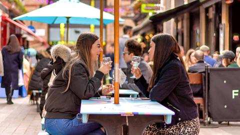 People enjoying food and drinks in Carnaby Street area