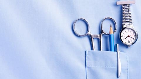 A close up of a nurse's pocket with nursing instruments 