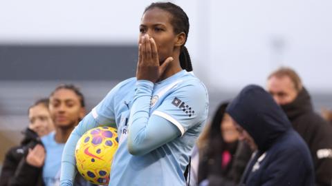 Khedija Shaw with her hand over her mouth