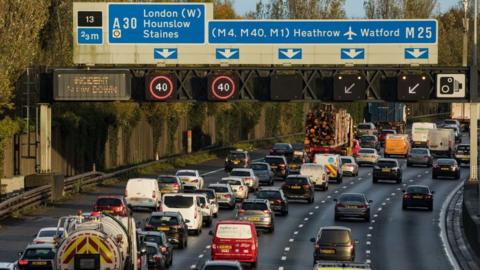 Vehicles are pictured queueing on the M25 between Junctions 12 and 13