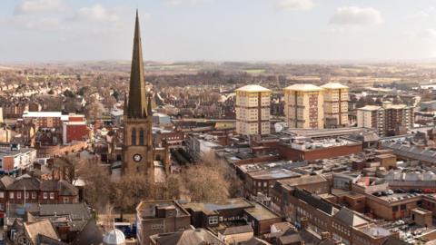 Wakefield cityscape, including Wakefield Cathedral and blocks of flats in the background