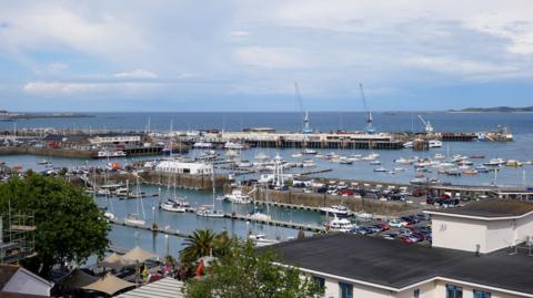 A view of St Peter Port harbour showing boats and docks