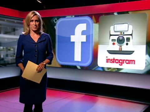 Sophie Raworth in the BBC News studio, on the left hand side of the frame in a dark blue dress holding a piece of paper in her left hand.  Behind her on the right hand side is a projection of a graphic of the Facebook and Instagram logos