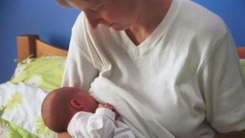 A mother breastfeeding a baby