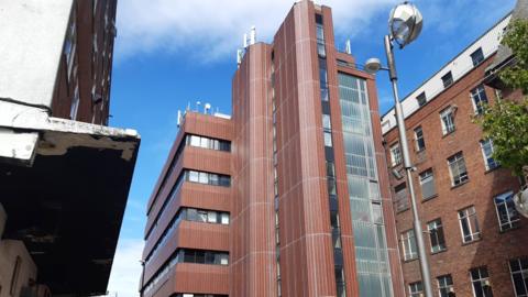 The Sunderland Telephone Exchange, on St Thomas Street. The tall tower-type building has several floors and brown cladding. There are antennas on the flat roof of the building.