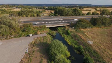 Aerial shot showing canal going under motorway.