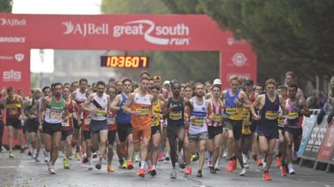 A group of runners at the start line of the race.