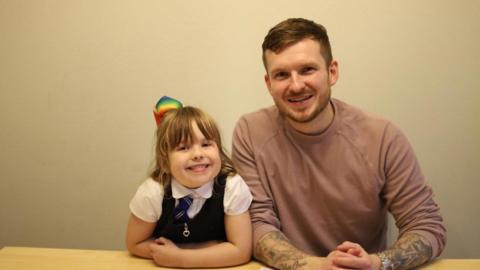 Blogger Daddy Freckle and his daughter sit at the kitchen table.