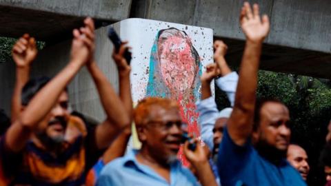 A mural of Prime Minister Sheikh Hasina is seen vandalised by protesters as people celebrate her resignation in Dhaka, Bangladesh, August 5, 2024