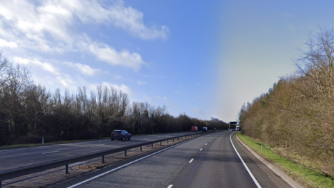 A general view of the A11 carriageway close to Red Lodge in Suffolk. The picture shows both sides of the carriageway which is lined with trees. Several cars can be seen 