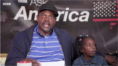 A father and daughter in Baltimore talk at the ˿'s Ask America event.