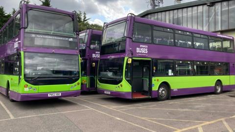 Double decker buses in green and purple livery of Ipswich Buses