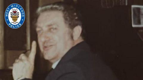 Side profile of a man pointing with index finger wearing a suit 