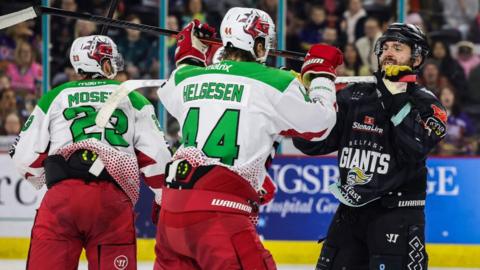 Cardiff Devils and Belfast Giants players go stick to stick