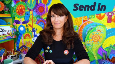 Liz Pichon sitting in front of colourful background. 