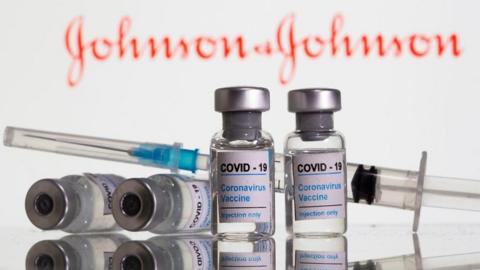 File photo: Vials labelled “Covid-19 Coronavirus vaccine” and a syringe are seen in front of a Johnson & Johnson logo