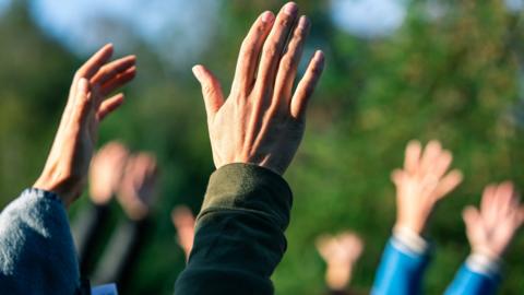 Worshippers' hands in air (stock image)