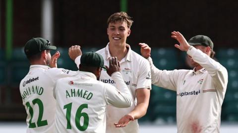 Josh Hull is congratulated by Leicestershire team-mates