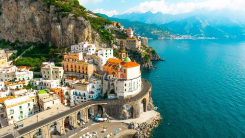 Aerial view of the stunning Amalfi coast with road and the Atrani town with arched road in Italy - stock photo