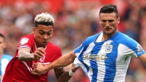 Middlesbrough's Morgan Rogers and Huddersfield Town's Matty Pearson battle for the ball during the Sky Bet Championship football match