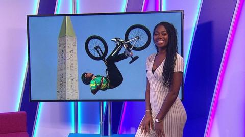 Shanequa in the studio with a BMX in the screen