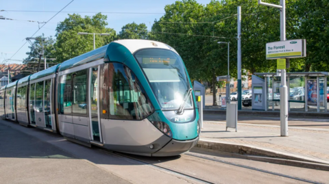 Tram at a tram stop in Nottingham