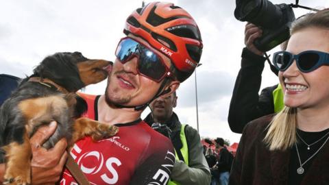 Tom Pidcock celebrates winning the 204 Amstel Gold Race with his girlfriend Bethany Zajac and their dog
