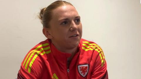 Ceri Holland speaks to the media