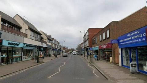 The image shows a high street, with shops on both sides such as Kokoro and Pret A Manger.