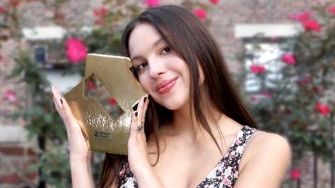 Olivia Rodrigo poses with her Official Chart award