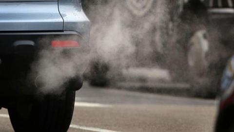 A car pouring fumes out of its exhaust