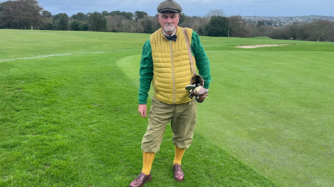 Paul East on a golf course wearing plus fours