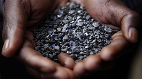 A Miner holds tantalum stones April 28, 2010 in Numbi in South Kivu Province, Democratic Republic of Congo.