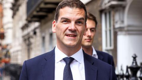 Olly Robbins pictured in a dark suit leaving the Cabinet Office on Whitehall