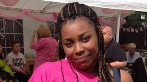 A photo of murder victim Lianne Gordon wearing a bright pink top and with braided hair. Lianne was fatally shot in Hackney.