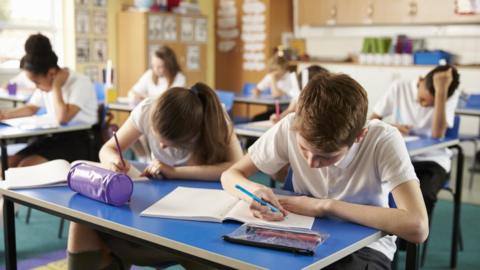 A school classroom where children are studying