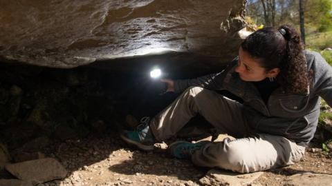 Joana Valdez-Tullett, research assistant on Scotland's Rock Art Project, looks at the carvings