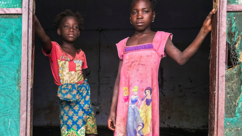 Children stand inside their house covered with mud after Tropical Storm Ana hit Mozambique - 27 January 2022