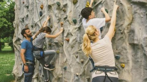 A family climbing a wall