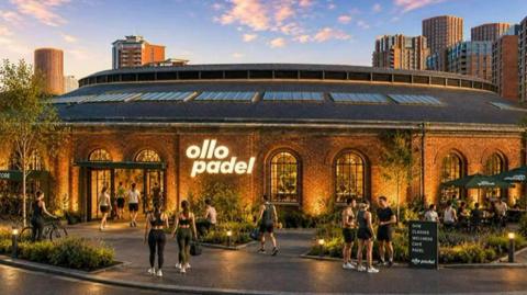 An architectural rendering of a sports and leisure venue called "ollo padel." The focal point of the image is a large circular red-brick building with a distinctive round roof. The roof features several long skylights, and a raised central section runs around the circumference of the structure. Illuminated signage on the front of the building displays the name "ollo padel" in large white letters.