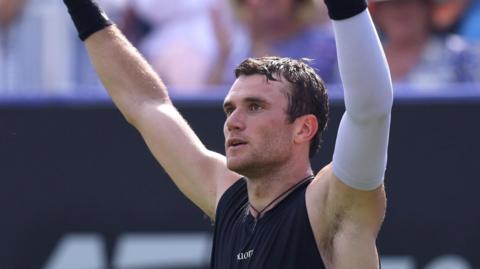 Jack Draper lifts his arms in celebration after winning his quarter-final at Eastbourne