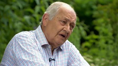 Henry Prince speaking to the 鶹Լ in 2014 on the 50th anniversary of the founding of the Red Arrows. He has grey hair and is wearing a chequered-patterned shirt.