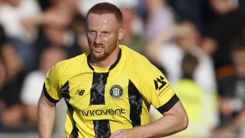 Liam Gibson in action for Harrogate Town