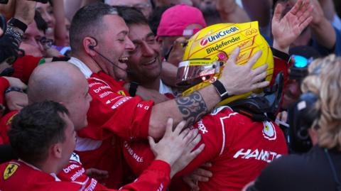 Lewis Hamilton celebrates with her Ferrari team after winning the Barcelona-Catalunya Grand Prix