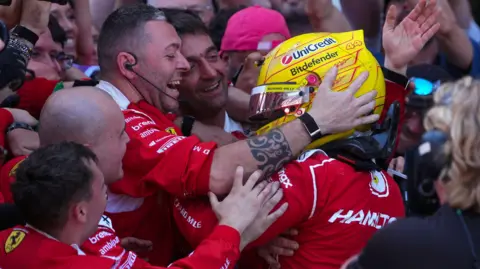 Lewis Hamilton celebrates with her Ferrari team after winning the Barcelona-Catalunya Grand Prix