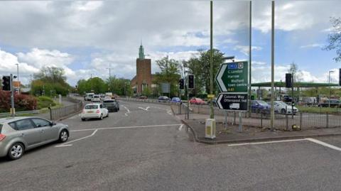 Exit from a roundabout showing cars in both directions